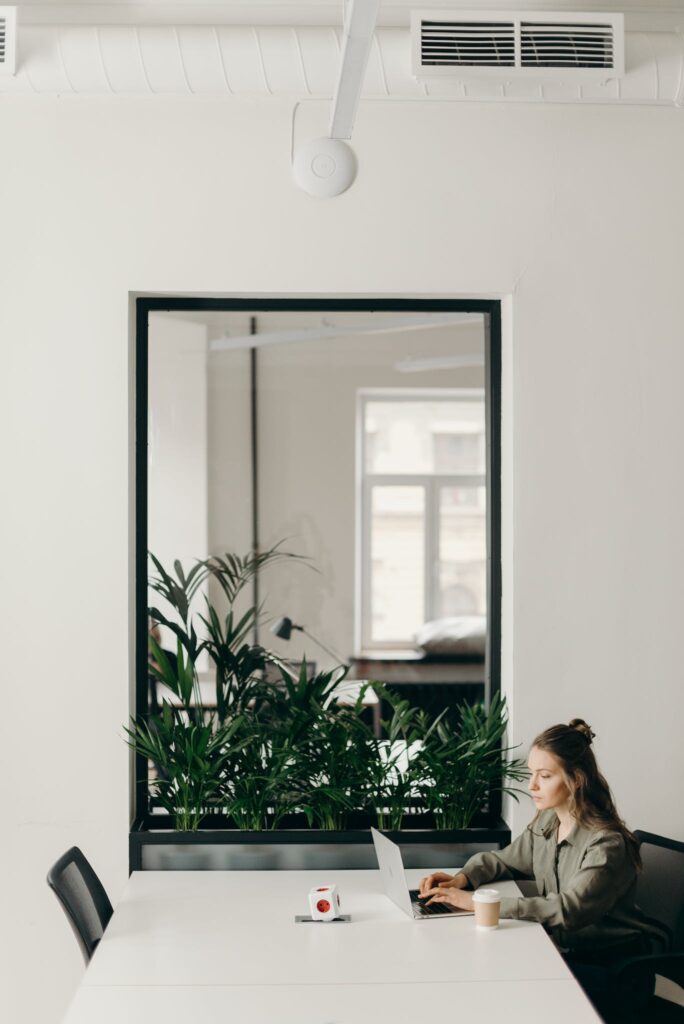 Photo of Woman Sitting on Chair While Using Laptop